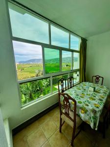 a dining room with a table and a large window at Peaceful Haven with Pool, Breathtaking View in Oued Laou