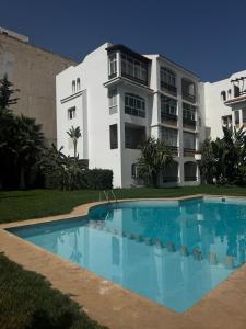 a building with a swimming pool in front of a building at Peaceful Haven with Pool, Breathtaking View in Oued Laou