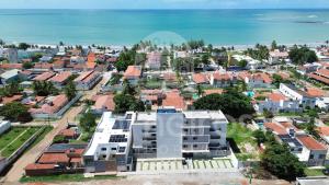 an aerial view of a city with houses and the ocean at Acqua Beach Residence by CTA in Tamandaré