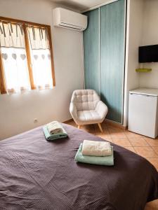 a bedroom with a bed with two towels on it at B&B Arghjola in Porto-Vecchio +26 photos