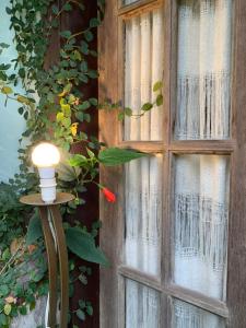a window with a light on the side of it at Chalé Vale do Amor in Araras Petropolis