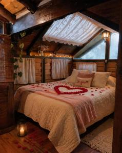 a bedroom with a bed in a room with a roof at Cabaña en la Calera con Sauna in La Calera