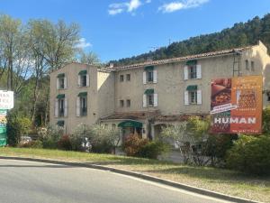 a large building on the side of a road at HUMAN HOTEL RESTAURANT Park in Villecroze