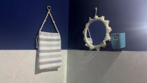 a mirror and a towel hanging on a wall at The Glory Apartment room 1 in Imphal