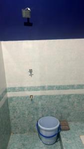 a blue bucket in a room with a wall at The Glory Apartment room 1 in Imphal