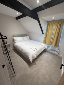 a bedroom with a white bed and a window at Windsor Flat 90C in Windsor