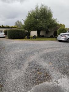 a parking lot with two cars parked in a driveway at Greenmount Accommodation in Killarney +3 photos