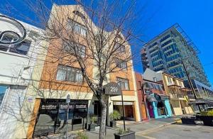 a tree in front of a building on a street at studio Ex hotel room city 107 in Adelaide