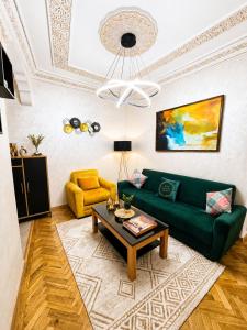 a living room with a green couch and a table at Elegant & Bright Flat in the Heart of Tangier in Tangier