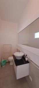a white bathroom with a sink and a toilet at Vilas Praia de Chaves Deluxe house sol y mar in Rabil +34 photos