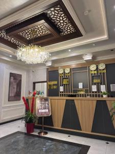 a hotel lobby with a reception desk and clocks at Almaz Hotel Uzbekistan in Tashkent
