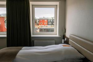 a bedroom with a bed and a window at Hotel Tórshavn in Tórshavn +29 photos