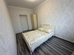 a bedroom with a bed in a room with wallpaper at Guest House in Gyumri in Gyumri
