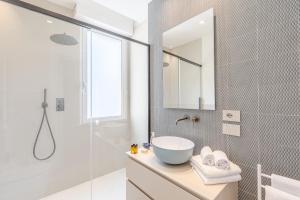 a bathroom with a sink and a glass shower at Luxury Suites Collection - Ceccarini in Riccione +26 photos