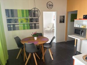 a kitchen and dining room with a table and chairs at Haus 4 you in Winden am See