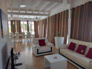 a living room with two white couches and a table at Vilas Praia de Chaves Deluxe house sol y mar in Rabil