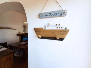 a wooden boat hanging on a wall at Casa Egy - ArgonautiVacanze in Casale Gastagno