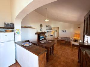 a kitchen and living room with a white refrigerator at Casa Egy - ArgonautiVacanze in Casale Gastagno +50 photos