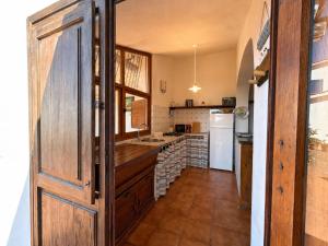 a kitchen with a sink and a refrigerator at Casa Egy - ArgonautiVacanze in Casale Gastagno
