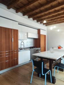 a kitchen with a table and chairs in a room at La Contrada - Suite Apartment in Sarnico