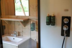 a bathroom with a sink and a mirror at Urban Gardens Ieper in Ieper