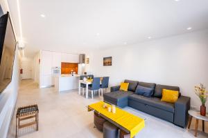 a living room with a couch and a table at #081 1BR Vale Mangude Pool & Location in Albufeira