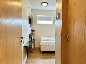 a room with a door and a bedroom with a bed at ALBERT Guesthouse in Hvammstangi
