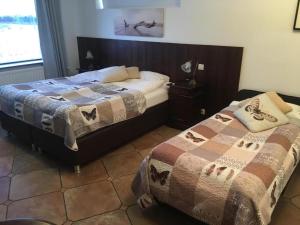 a bedroom with two beds and a window at Hotel Skógá by EJ Hotels in Skogar