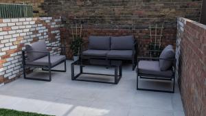 three chairs and a coffee table on a patio at Seibiant in Ramsgate