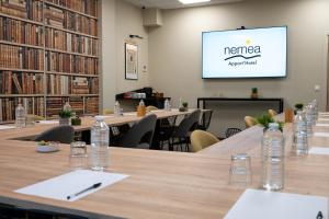 a conference room with tables and chairs and a screen at Nemea Appart Hotel Sunset Nice Arenas in Nice +23 photos