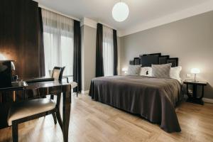 a hotel room with a bed and a desk at Hotel Borg by Keahotels in Reykjavík