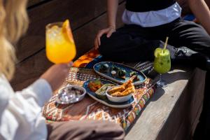 a table with a plate of food and a drink at Manon Les Suites Guldsmeden in Copenhagen