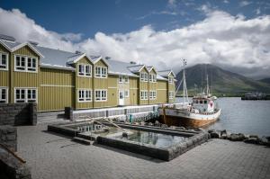 a boat is docked in front of a building at Siglo Hotel by Keahotels in Siglufjörður