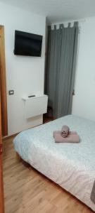 a bedroom with a bed with a towel on it at B&B Ca' d'Andrea in San Martino +14 photos