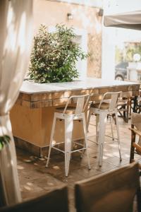 a table and chairs in front of a bar at GIARDINO High living suites in Drama +13 photos