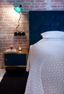a bedroom with a bed and a lamp on the wall at Five Rooms in Leer