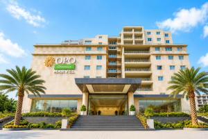 a hotel with palm trees in front of it at OPO Premier Marvel in Jaipur