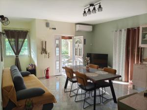 a living room with a table and a couch at Marathi Apartment in Marathias
