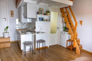 a kitchen with a counter and stools in a room at Mourisco Guest House in Alijó
