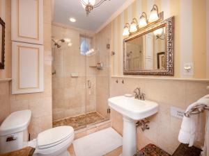a bathroom with a toilet and a sink and a mirror at La Reserve On Pine in Philadelphia +89 photos