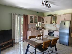 a kitchen with a table and chairs and a refrigerator at Marathi Apartment in Marathias