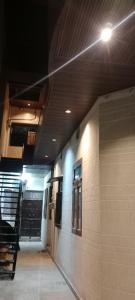 a hallway of a building with a light on the ceiling at Hari Sharnam Residency in Mathura