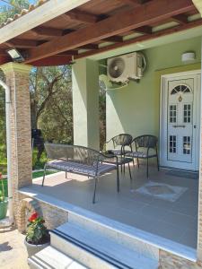 a patio with two chairs and a table at Marathi Apartment in Marathias