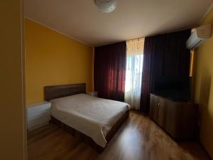 a small bedroom with a bed and a television at Casa Daria Oradea in Oradea +11 photos