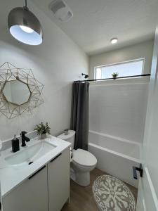 a bathroom with a sink and a toilet and a mirror at New Casita by Zion National Park and Saint George in Hurricane +7 photos