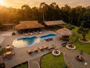 an aerial view of a pool with tables and chairs at Loop Tribe Hostel in Ha Giang