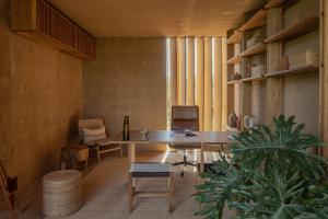 a room with a table and chairs and a plant at Paradero Todos Santos - Exclusive experiences included in Todos Santos