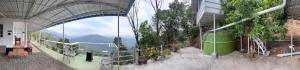 a building with a balcony with a view of a mountain at Misty Moutain view in Pīrmed