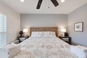 a bedroom with a large bed with two lamps at Bay Tree B3 in Port Aransas