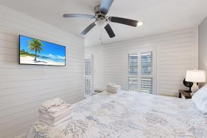 a bedroom with a bed and a ceiling fan at Bay Tree B3 in Port Aransas +45 photos
